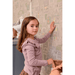 Majvillan Dollhouse Wallpaper 147-02 girl looking at camera putting stickers on wall