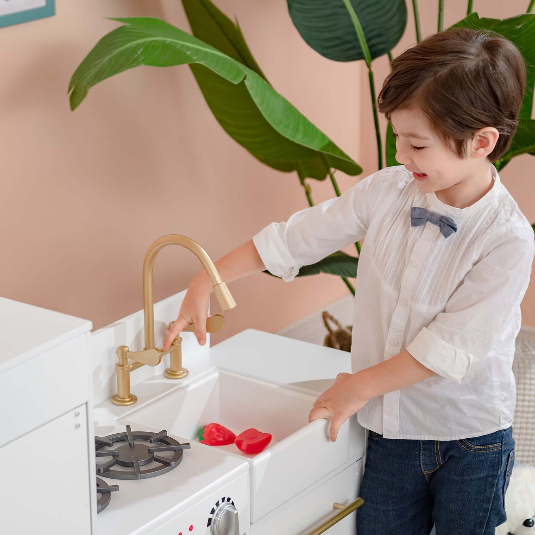 Teamson Kids Little Chef Charlotte Modern Play Kitchen, White/Gold TD-12302WR child playing with sink